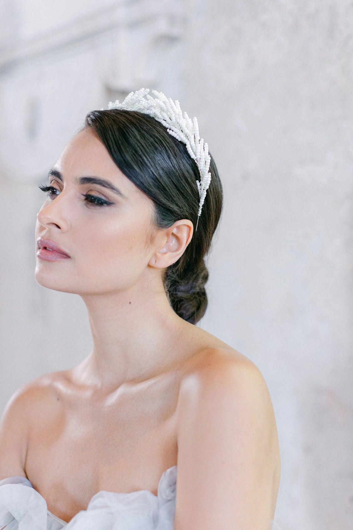 Weidezoet elegante bruidskroon van Hanna Peters × Gibson Bespoke met handgemaakte botanische takken van glanzende ivoorkleurige glaskralen in een verfijnde Griekse stijl.